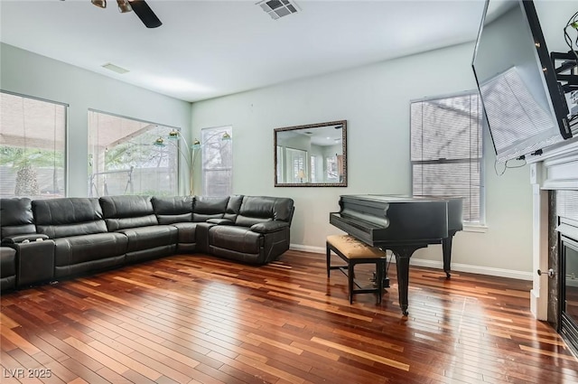 313 Glenridding St, Las Vegas, NV 89183 - living room with wood-type flooring, plenty of natural light, a ceiling fan, and a glass covered fireplace