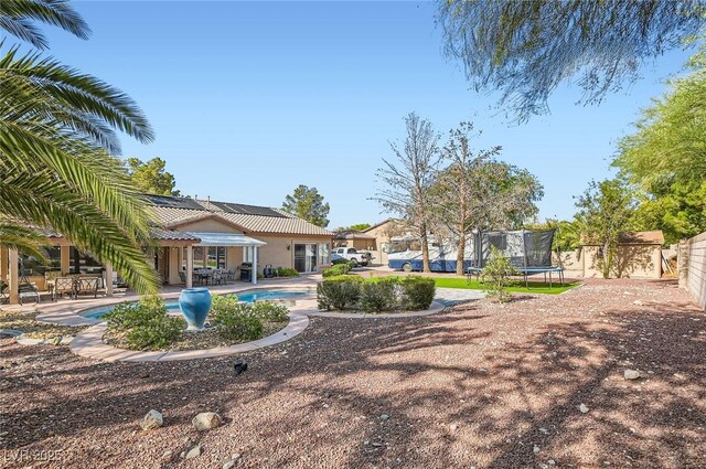 313 Glenridding St, Las Vegas, NV 89183 - view of yard with a patio area and a trampoline