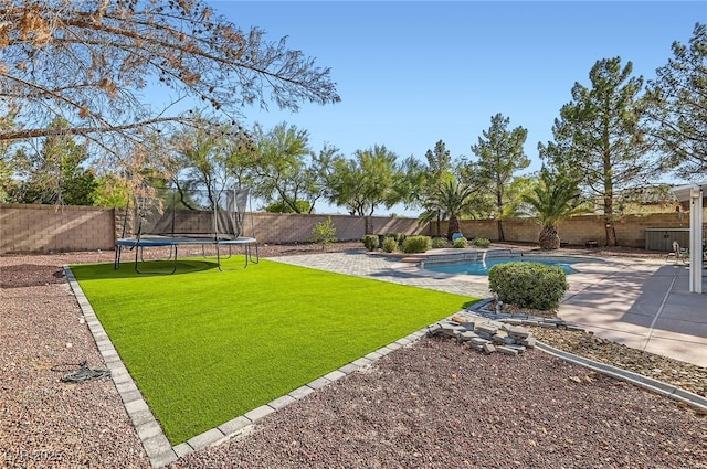 313 Glenridding St, Las Vegas, NV 89183 - fenced backyard with a trampoline and a patio area