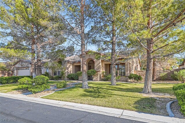 313 Glenridding St, Las Vegas, NV 89183 - mediterranean / spanish-style house with stucco siding and a front yard