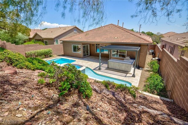 81 Alerion St, Las Vegas, NV 89138 - rear view of property featuring french doors, a fenced backyard, a patio area, stucco siding, and a tiled roof