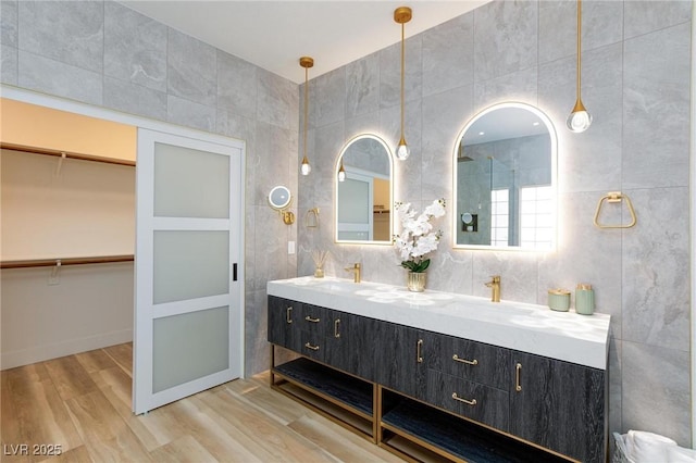 81 Alerion St, Las Vegas, NV 89138 - full bath featuring double vanity, tile walls, wood finished floors, and a walk in closet