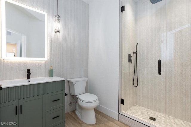 81 Alerion St, Las Vegas, NV 89138 - full bath featuring wood finished floors, toilet, a shower stall, vanity, and baseboards