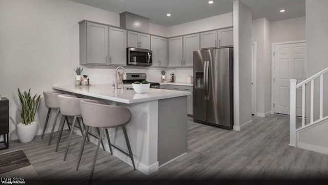 1168 Heliodor Ave Lot 152, Henderson, NV 89011 - kitchen with appliances with stainless steel finishes, gray cabinets, a peninsula, baseboards, and recessed lighting