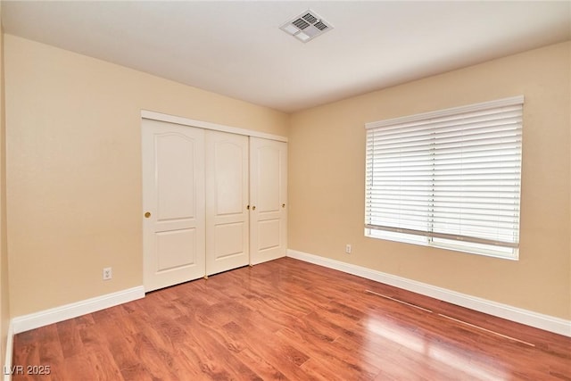 9413 Cedar Heights Ave, Las Vegas, NV 89134 - unfurnished bedroom with baseboards, wood finished floors, and a closet