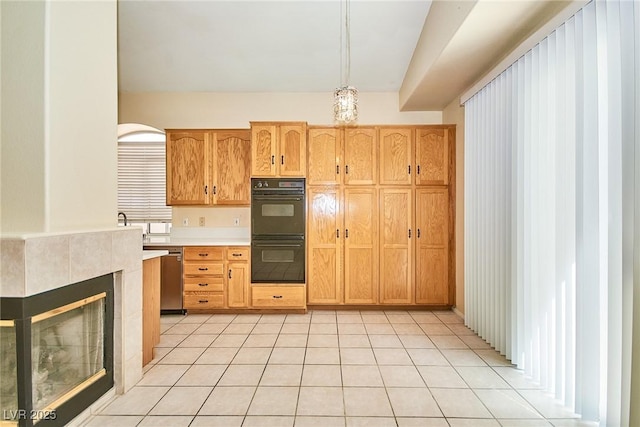 9413 Cedar Heights Ave, Las Vegas, NV 89134 - kitchen featuring light countertops, light tile patterned flooring, hanging light fixtures, and a tiled fireplace