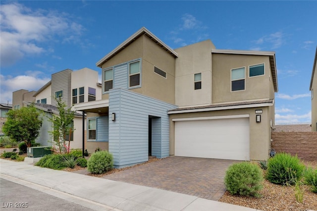 2651 Deep Canyon St, Henderson, NV 89044 - view of front of home featuring a garage, decorative driveway, and stucco siding