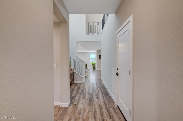 2651 Deep Canyon St, Henderson, NV 89044 - hall featuring stairway, wood finished floors, and a textured wall