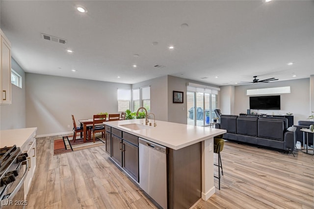 2651 Deep Canyon St, Henderson, NV 89044 - kitchen featuring stainless steel appliances, light wood-type flooring, light countertops, a kitchen island with sink, and recessed lighting
