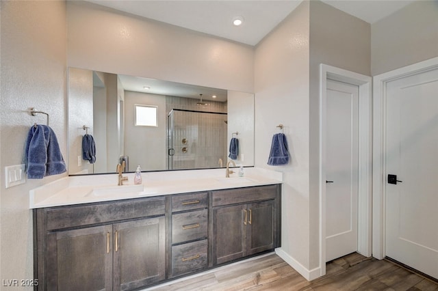 2651 Deep Canyon St, Henderson, NV 89044 - full bathroom featuring a shower stall, double vanity, and wood finished floors