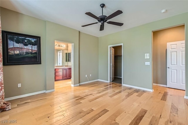 62 Myrtle Springs Ct, Las Vegas, NV 89148 - unfurnished bedroom with light wood finished floors, baseboards, and a walk in closet