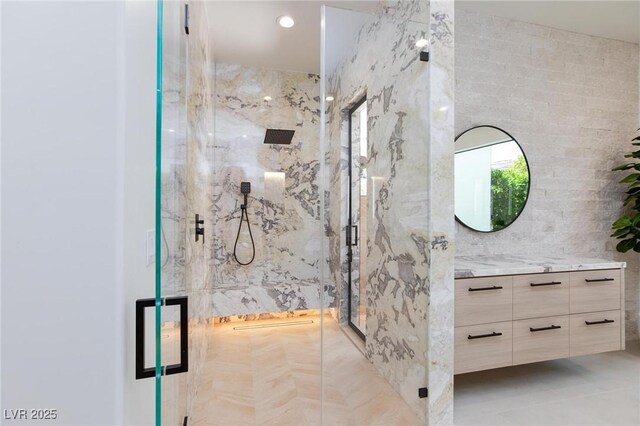 11926 Port Labelle Dr, Las Vegas, NV 89141 - bathroom with vanity, a marble finish shower, and tile walls