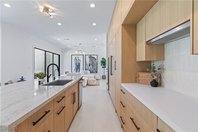 11926 Port Labelle Dr, Las Vegas, NV 89141 - kitchen featuring light brown cabinets, light stone counters, open floor plan, recessed lighting, and tasteful backsplash