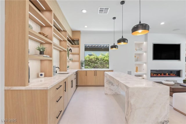 11926 Port Labelle Dr, Las Vegas, NV 89141 - kitchen with open shelves, light brown cabinets, modern cabinets, light stone counters, and built in shelves