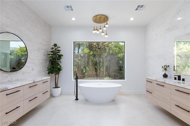 11926 Port Labelle Dr, Las Vegas, NV 89141 - bathroom featuring two vanities, a soaking tub, and recessed lighting