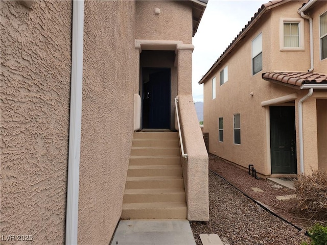 5052 Whistling Acres Ave, Las Vegas, NV 89131 - doorway to property featuring stucco siding and a tile roof
