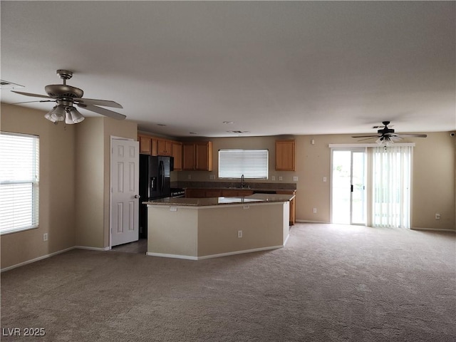 5052 Whistling Acres Ave, Las Vegas, NV 89131 - kitchen featuring a ceiling fan, open floor plan, light carpet, and a center island