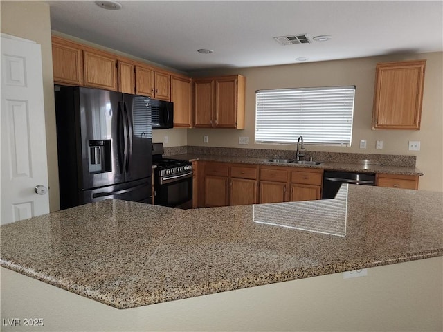 5052 Whistling Acres Ave, Las Vegas, NV 89131 - kitchen featuring refrigerator with ice dispenser, a sink, stainless steel range with gas cooktop, dishwashing machine, and black microwave