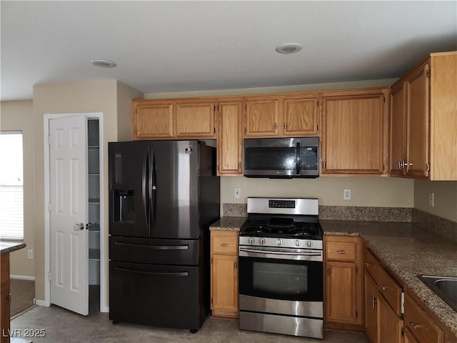 5052 Whistling Acres Ave, Las Vegas, NV 89131 - kitchen featuring black appliances, a sink, and brown cabinets