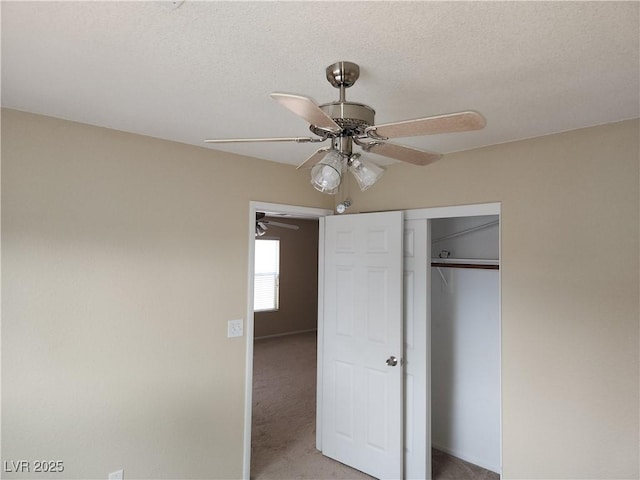 5052 Whistling Acres Ave, Las Vegas, NV 89131 - unfurnished bedroom featuring light colored carpet, a closet, a textured ceiling, and a ceiling fan