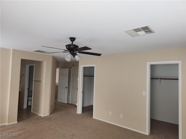 5052 Whistling Acres Ave, Las Vegas, NV 89131 - unfurnished bedroom with a spacious closet, carpet floors, baseboards, and connected bathroom