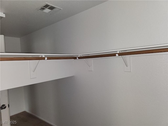 5052 Whistling Acres Ave, Las Vegas, NV 89131 - spacious closet featuring dark colored carpet