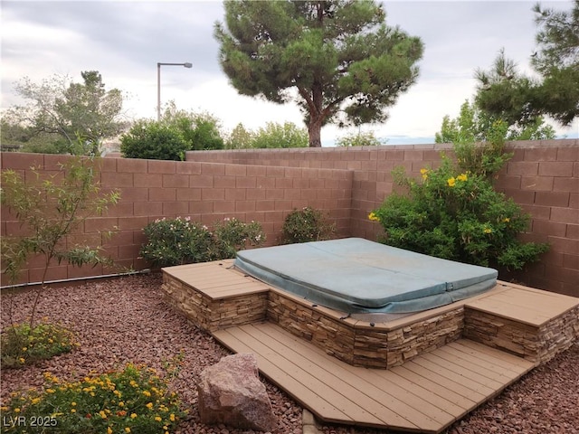 5052 Whistling Acres Ave, Las Vegas, NV 89131 - fenced backyard with a covered hot tub and a wooden deck