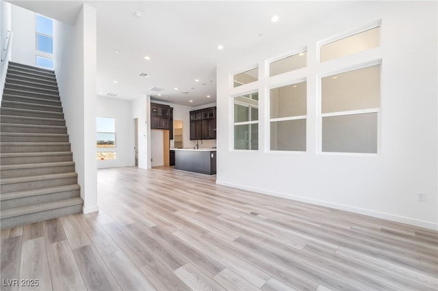 2501 Indigo Mountain St, Henderson, NV 89044 - unfurnished living room with stairway, light wood-style flooring, recessed lighting, and baseboards
