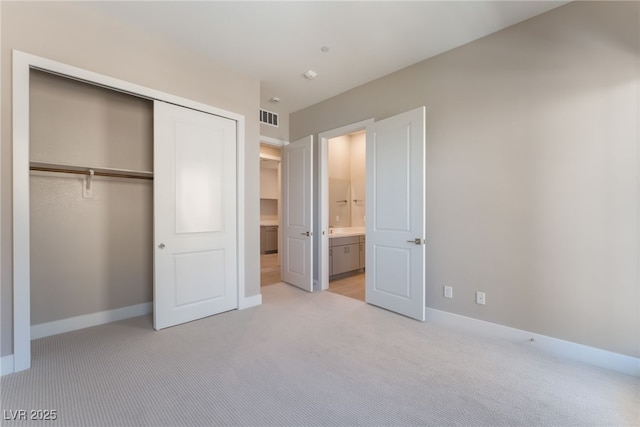 128 Los Cabos Dr Unit 301, Las Vegas, NV 89144 - unfurnished bedroom featuring light colored carpet, baseboards, a closet, and connected bathroom