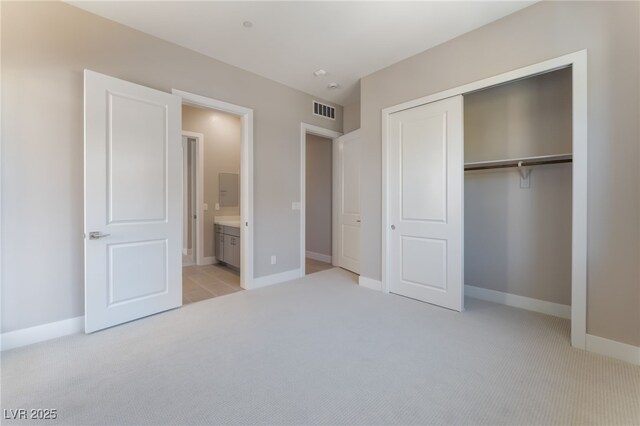 128 Los Cabos Dr Unit 301, Las Vegas, NV 89144 - unfurnished bedroom with light carpet, a closet, and baseboards