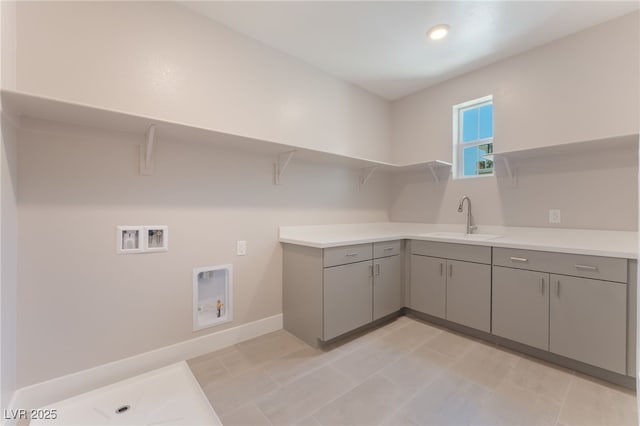 128 Los Cabos Dr Unit 301, Las Vegas, NV 89144 - laundry room with hookup for a washing machine, baseboards, and cabinet space
