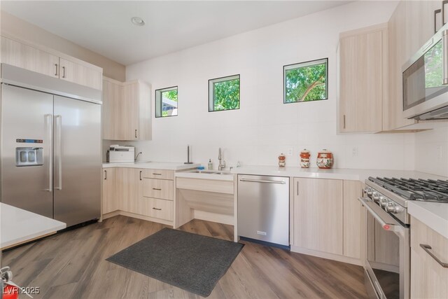 128 Los Cabos Dr Unit 301, Las Vegas, NV 89144 - kitchen with light brown cabinetry, premium appliances, light countertops, and modern cabinets