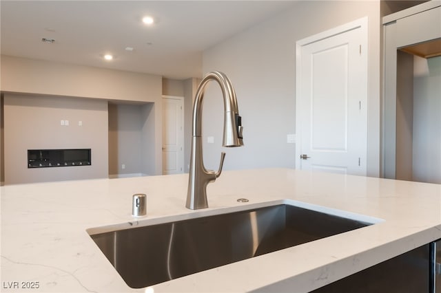 128 Los Cabos Dr Unit 301, Las Vegas, NV 89144 - kitchen with a sink, light stone counters, and recessed lighting
