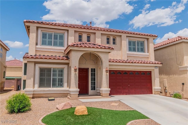 6558 Musette Ave, Las Vegas, NV 89139 - mediterranean / spanish-style home with a garage, driveway, a tiled roof, and stucco siding