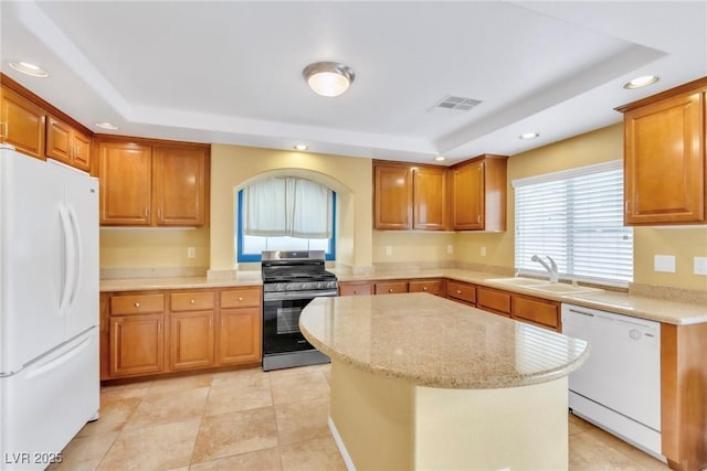 6558 Musette Ave, Las Vegas, NV 89139 - kitchen featuring white appliances, a raised ceiling, a sink, recessed lighting, and a center island