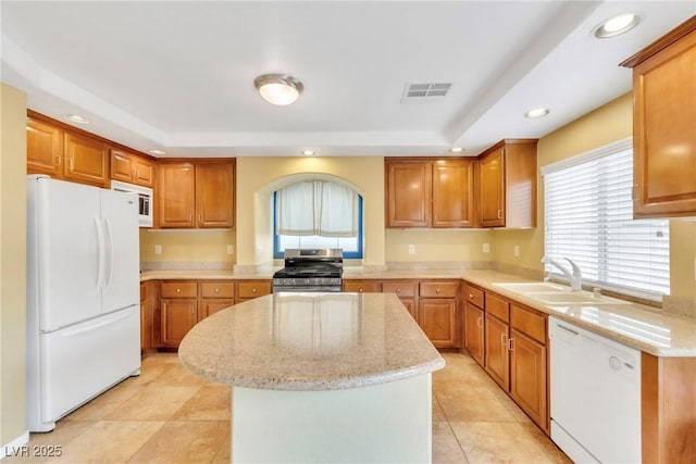 6558 Musette Ave, Las Vegas, NV 89139 - kitchen featuring white appliances, a sink, a tray ceiling, a center island, and recessed lighting