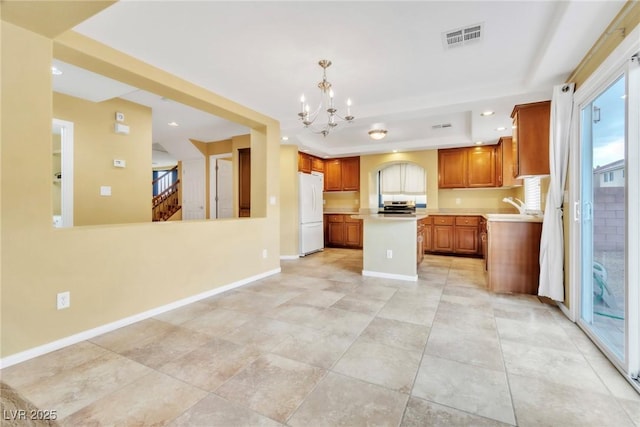 6558 Musette Ave, Las Vegas, NV 89139 - kitchen featuring freestanding refrigerator, a chandelier, light countertops, stainless steel range oven, and a kitchen island