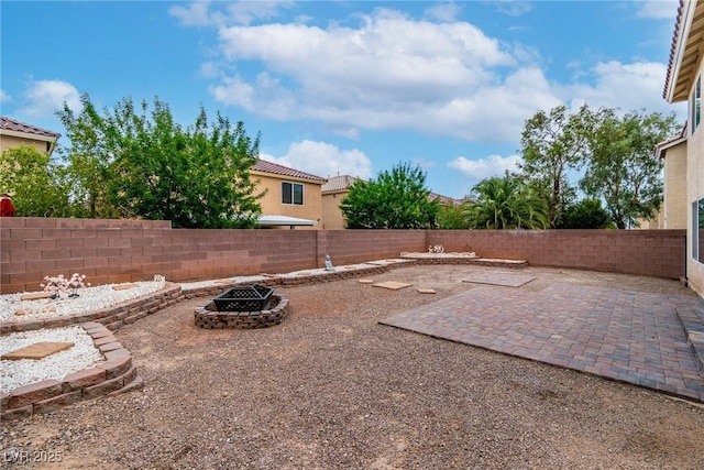 6558 Musette Ave, Las Vegas, NV 89139 - fenced backyard with an outdoor fire pit and a patio