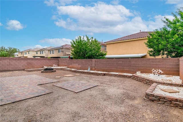6558 Musette Ave, Las Vegas, NV 89139 - fenced backyard featuring a patio area, a fire pit, and a residential view