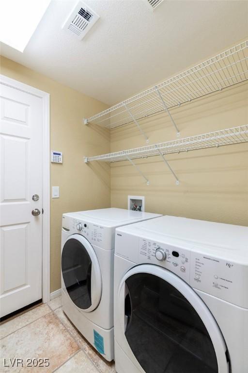 6558 Musette Ave, Las Vegas, NV 89139 - laundry room featuring independent washer and dryer, light tile patterned floors, and baseboards