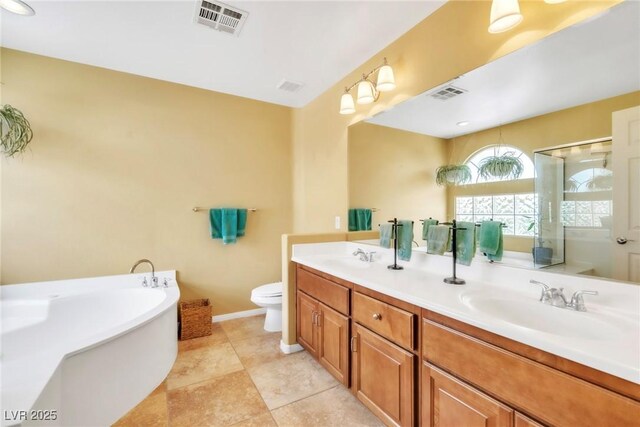 6558 Musette Ave, Las Vegas, NV 89139 - bathroom with toilet, a freestanding bath, double vanity, a shower stall, and baseboards