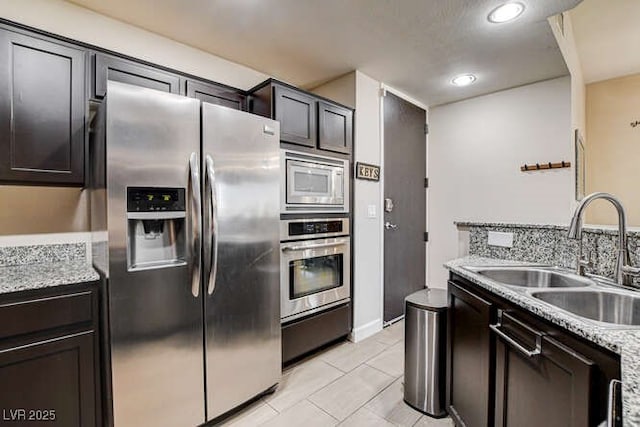 83 E Agate Ave Unit 207, Las Vegas, NV 89123 - kitchen with appliances with stainless steel finishes, light tile patterned floors, recessed lighting, and light stone counters