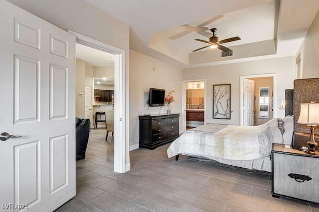 83 E Agate Ave Unit 207, Las Vegas, NV 89123 - bedroom featuring a raised ceiling, connected bathroom, and a ceiling fan
