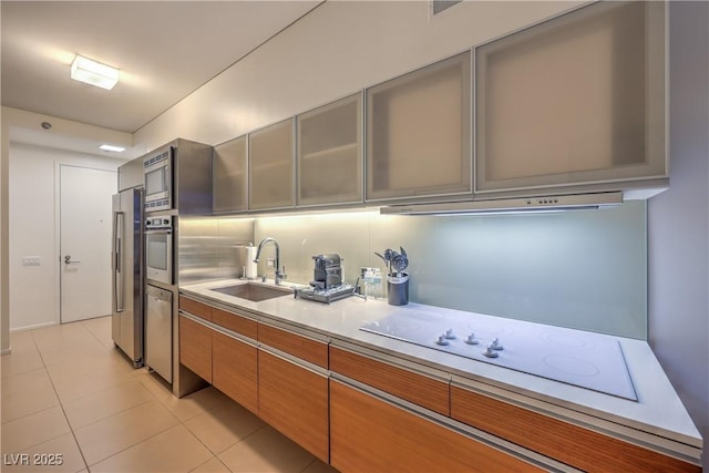 3726 Las Vegas Blvd Unit 3105, Las Vegas, NV 89158 - kitchen with a sink, stainless steel appliances, light countertops, under cabinet range hood, and light tile patterned floors