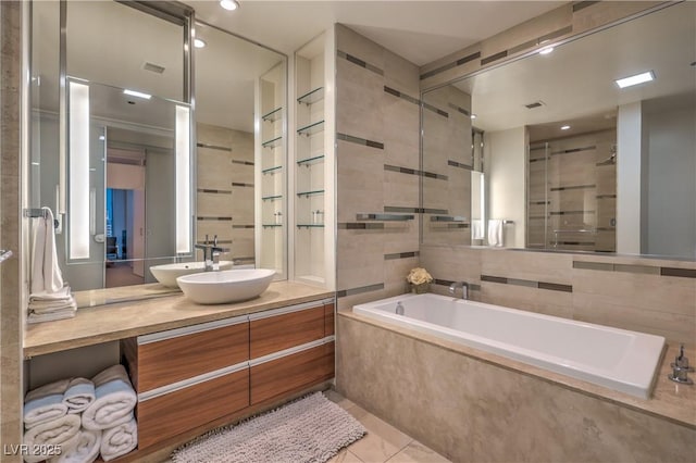 3726 Las Vegas Blvd Unit 3105, Las Vegas, NV 89158 - bathroom featuring a garden tub, vanity, tile walls, tile patterned floors, and recessed lighting