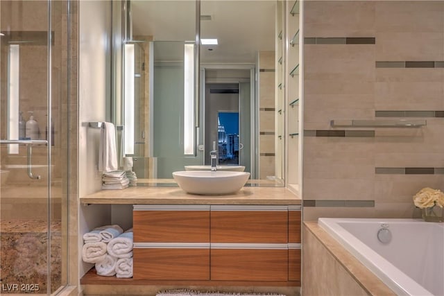 3726 Las Vegas Blvd Unit 3105, Las Vegas, NV 89158 - bathroom featuring vanity, a shower stall, and tiled tub