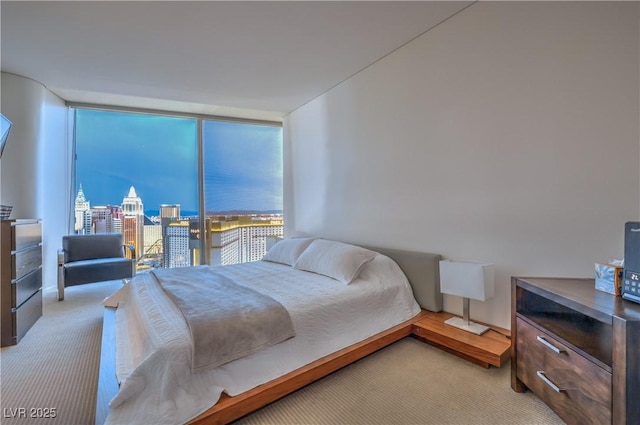 3726 Las Vegas Blvd Unit 3105, Las Vegas, NV 89158 - bedroom with light carpet, expansive windows, and a city view
