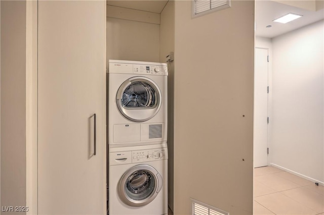 3726 Las Vegas Blvd Unit 3105, Las Vegas, NV 89158 - washroom with stacked washing machine and dryer and light tile patterned flooring