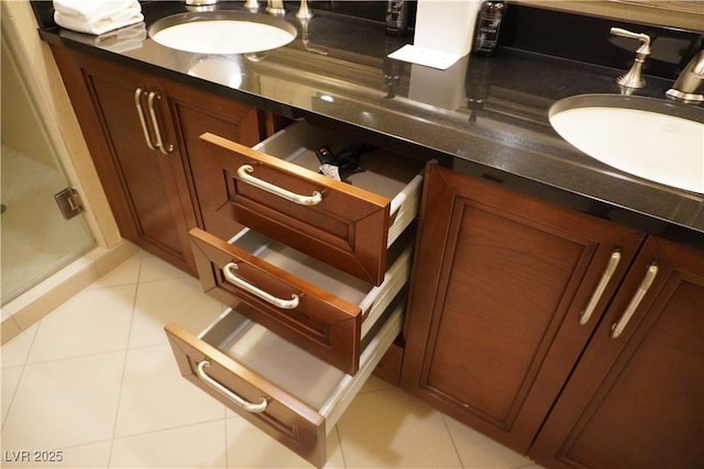 145 E Harmon Ave Unit 27619, Las Vegas, NV 89109 - bathroom featuring tile patterned flooring, vanity, and a shower stall