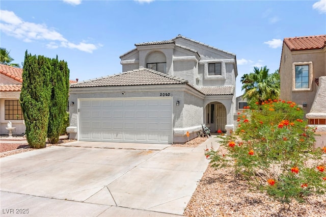 2062 Club Crest Way, Henderson, NV 89014 - mediterranean / spanish-style house with a garage, a tile roof, stucco siding, and driveway